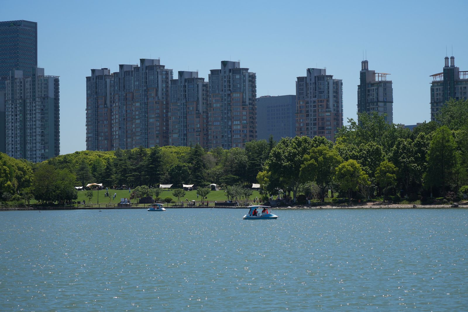 Shanghai high-rise buildings above a lake with small boats