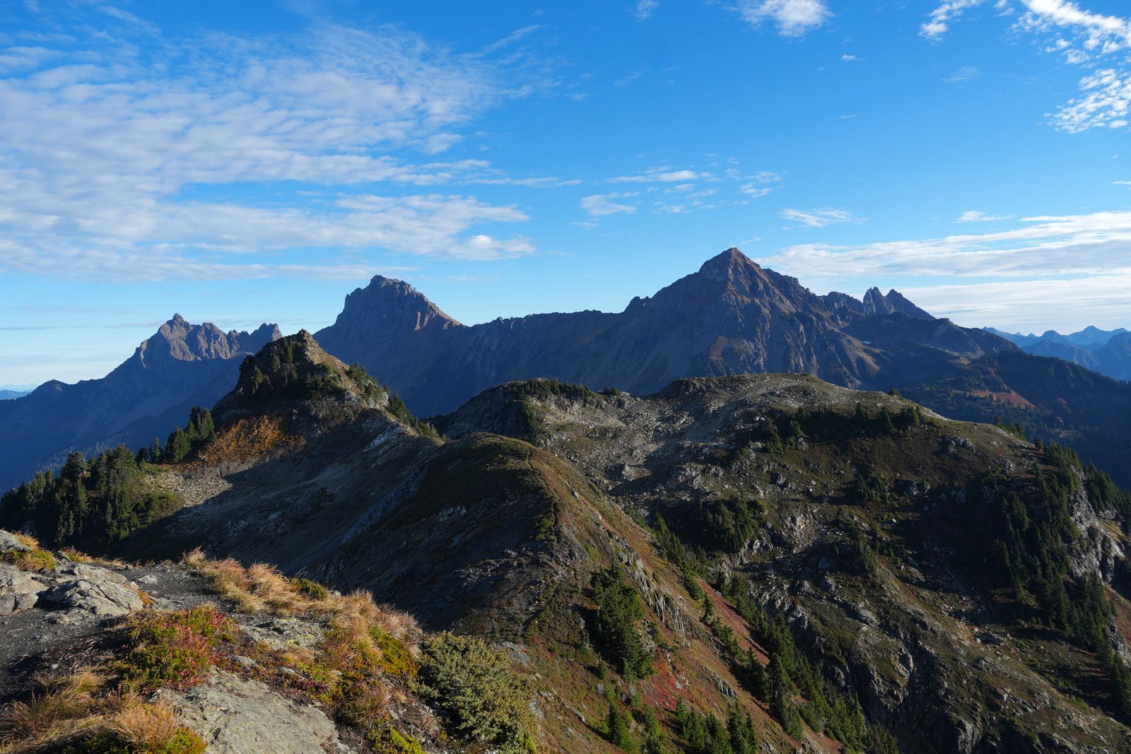 Rocky peaks above ridges with red and gold groundcover, Yellow Aster Butte