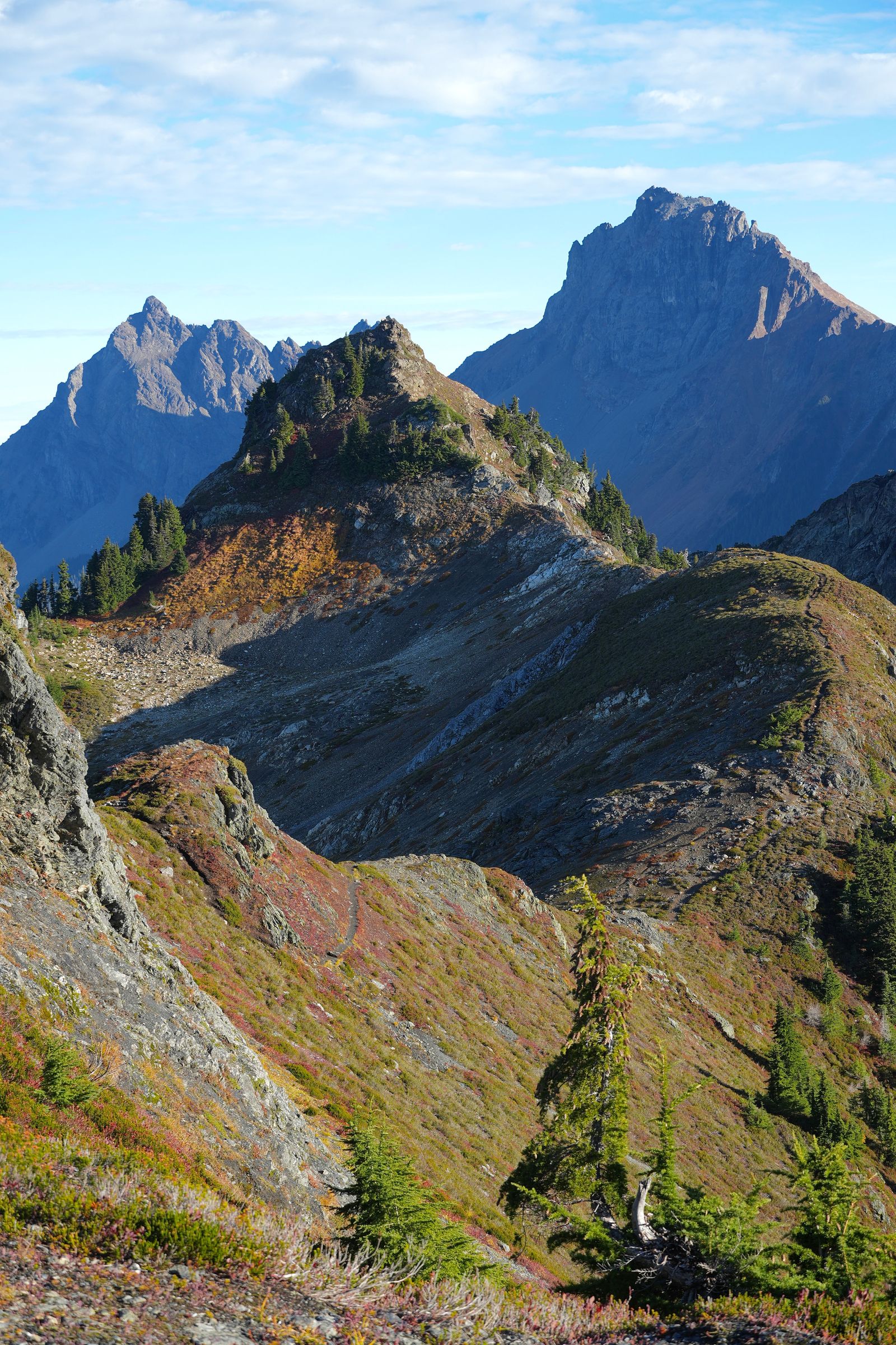 Rocky mountain ridges above a hillside trail and fall colors, Yellow Aster Butte
