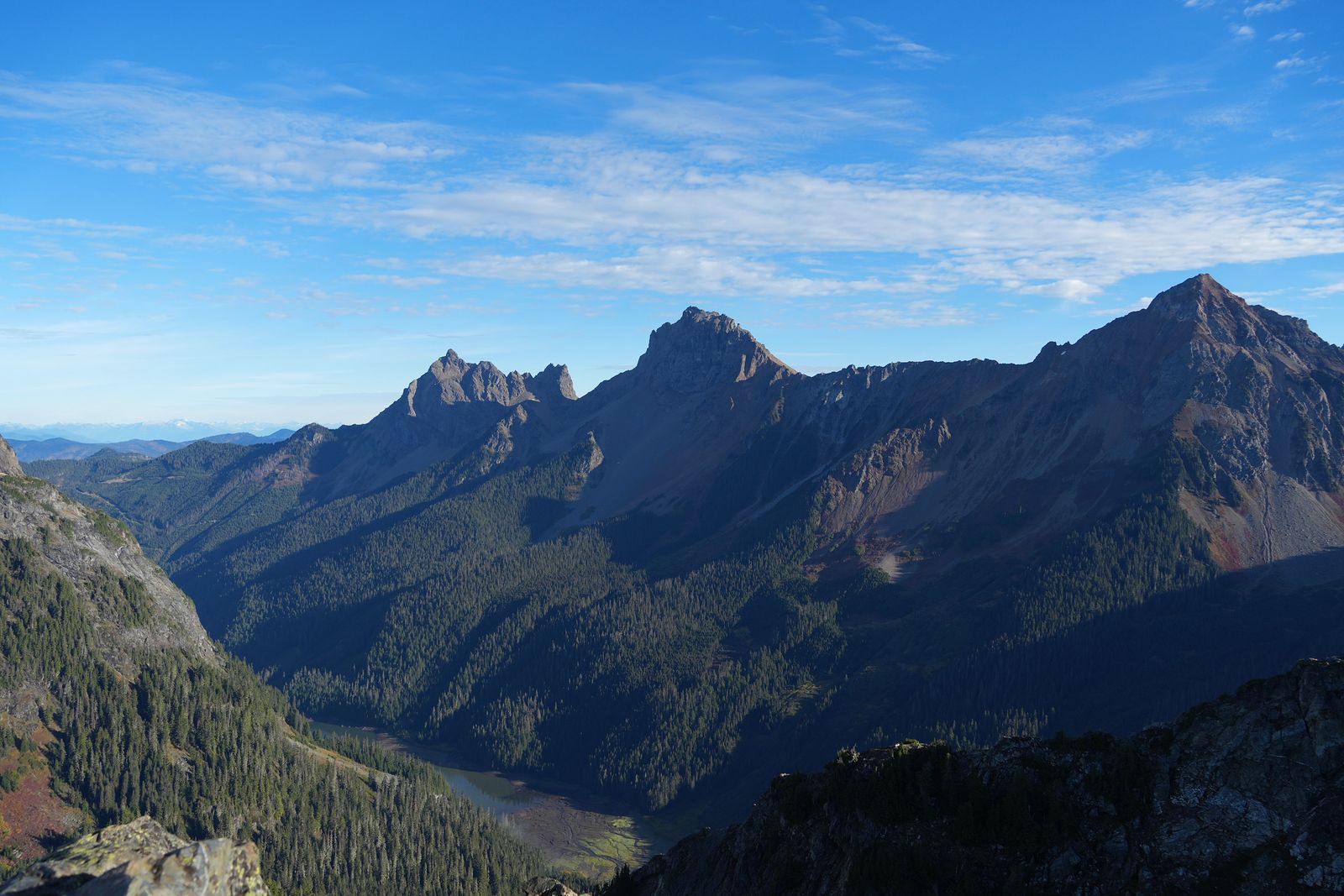 Rocky peaks above a forested valley and tarn, Yellow Aster Butte