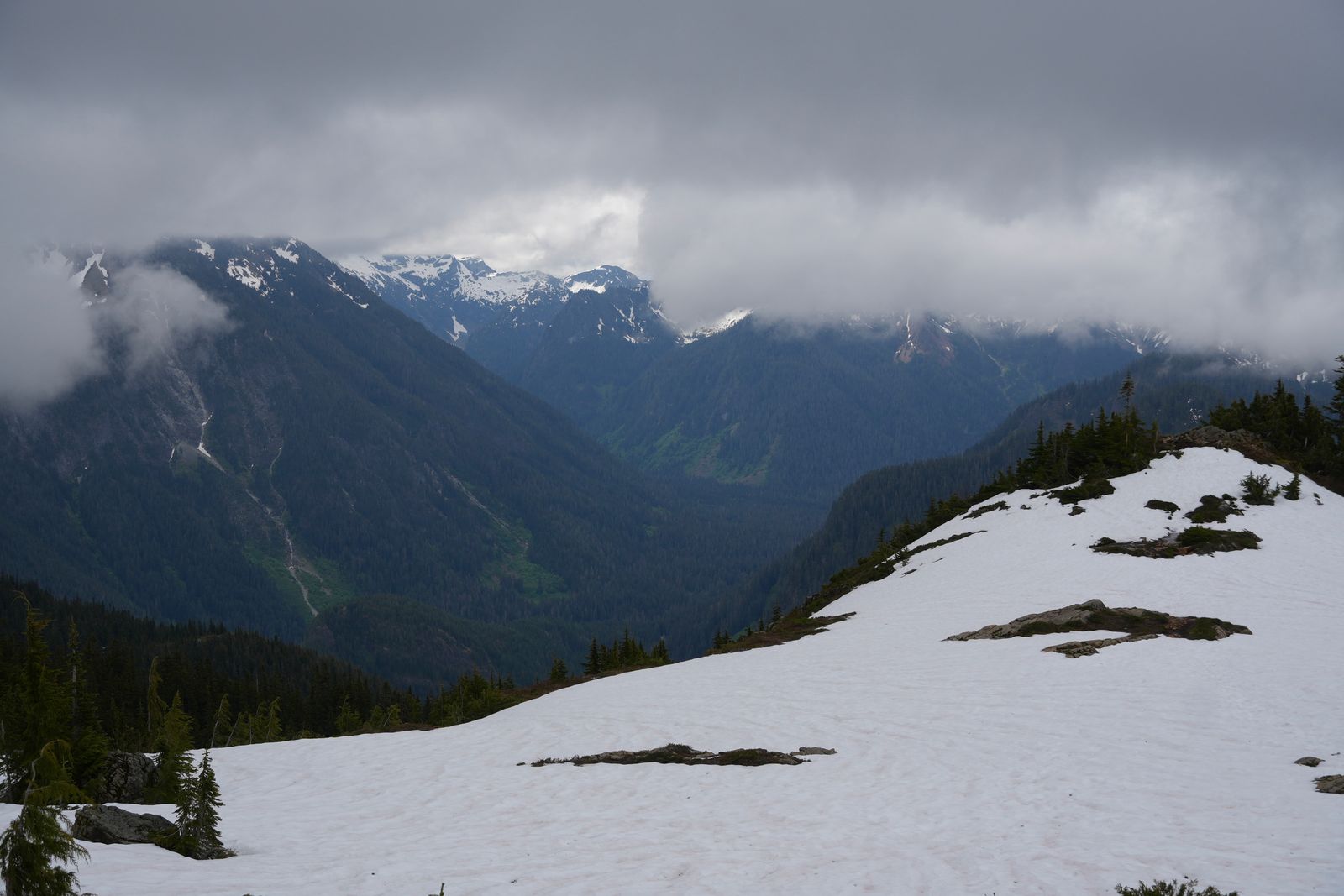 Snow-patched mountains above a forested valley under low clouds, Ball Mountain