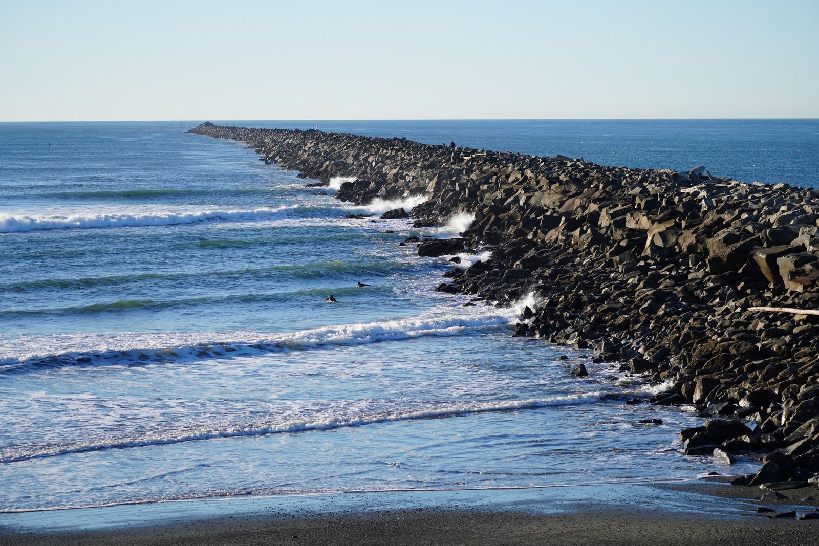 A rock breakwater beside breaking waves at Westport