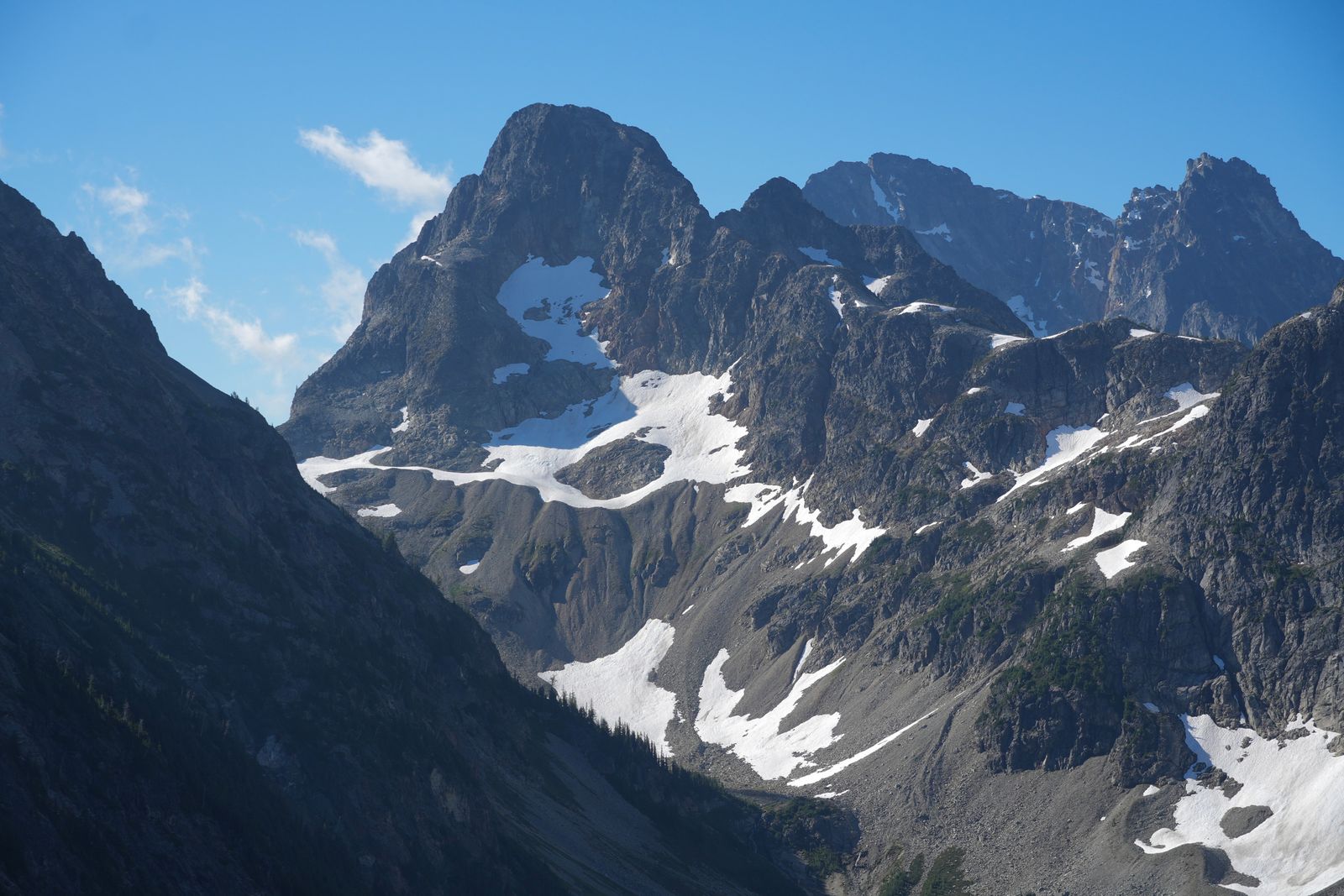 North Cascades peaks above snow-streaked rocky slopes, Washington Pass