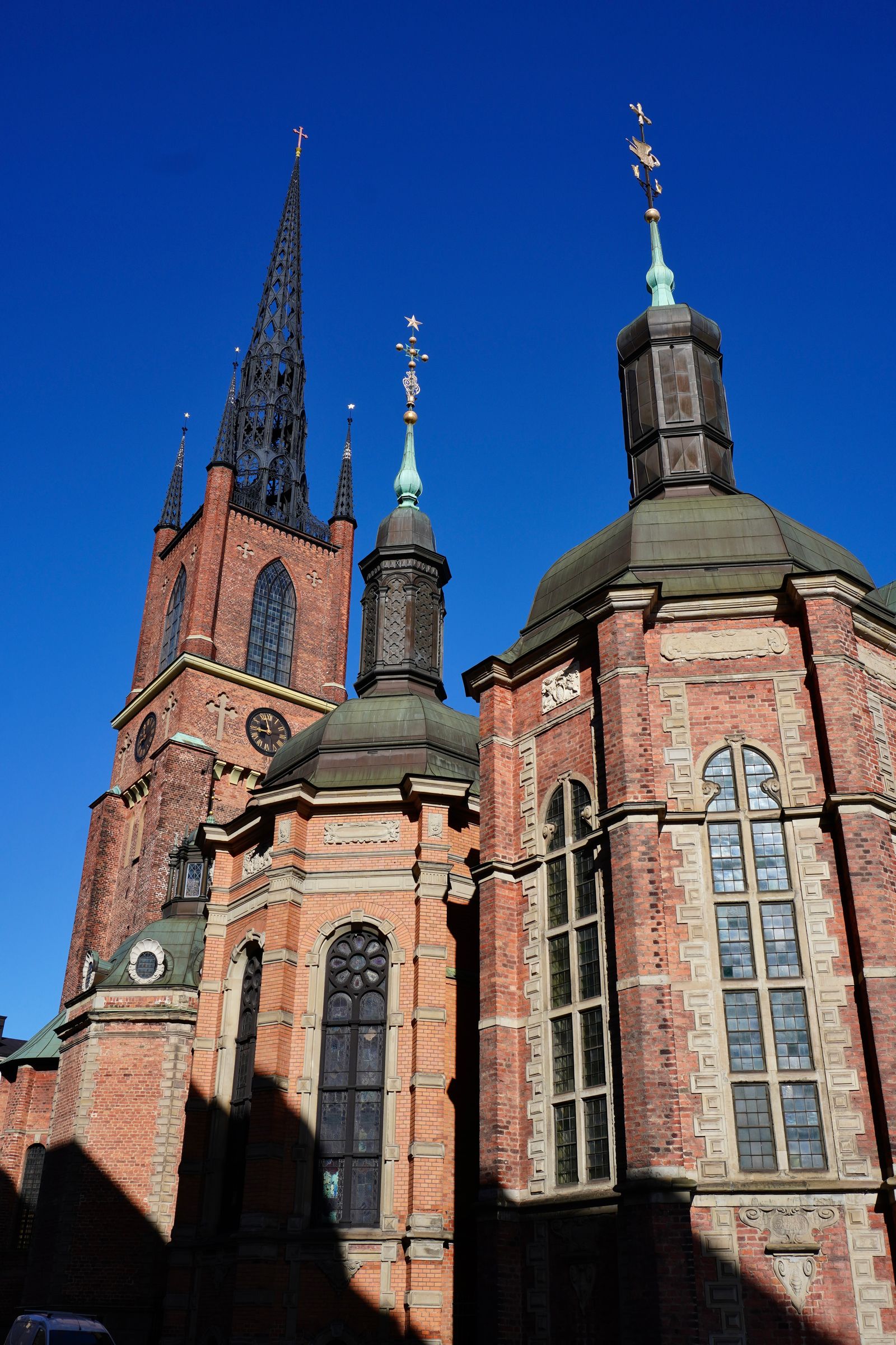 Red brick church with an openwork spire and roof towers, Stockholm