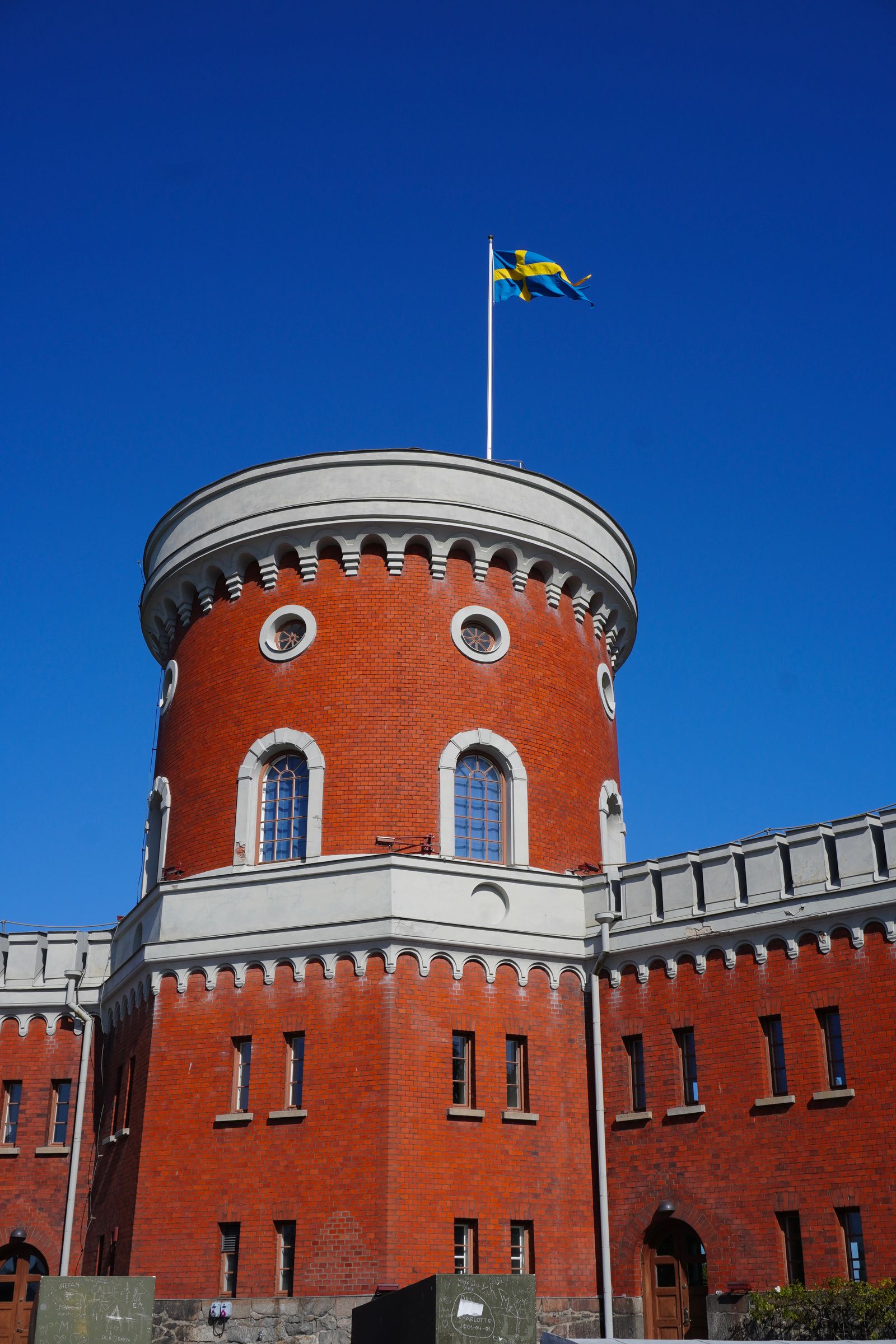 Round red brick tower flying a blue and yellow flag, Stockholm