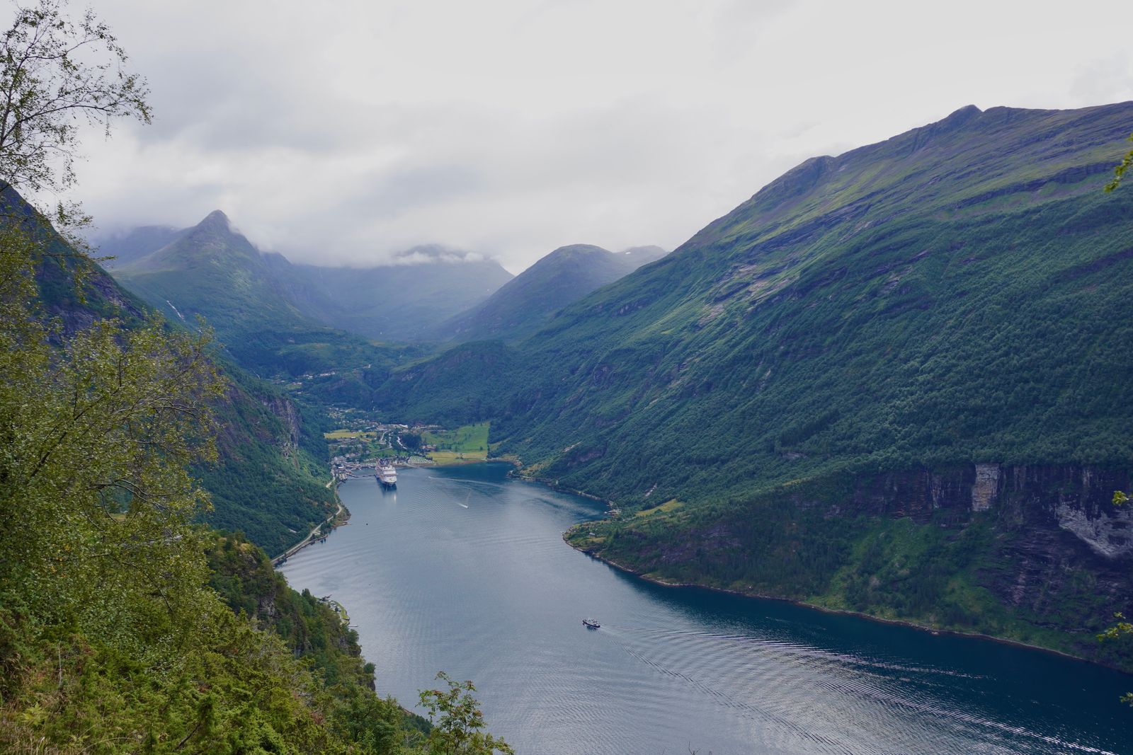 Fjord at Geiranger with boats beneath low clouds