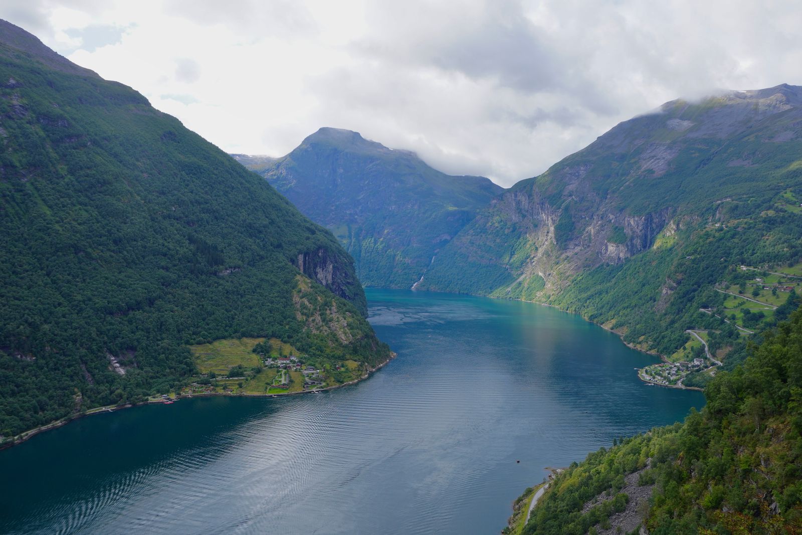 Fjord winding between green mountains and shoreline settlements, Geiranger