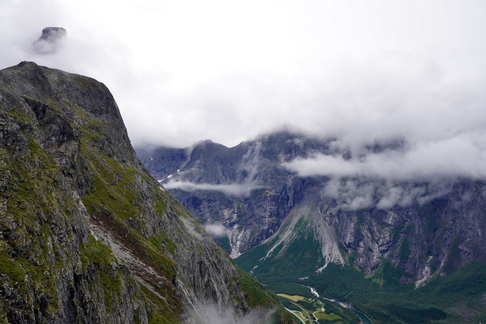 Rocky mountains above a winding river in low cloud, Åndalsnes