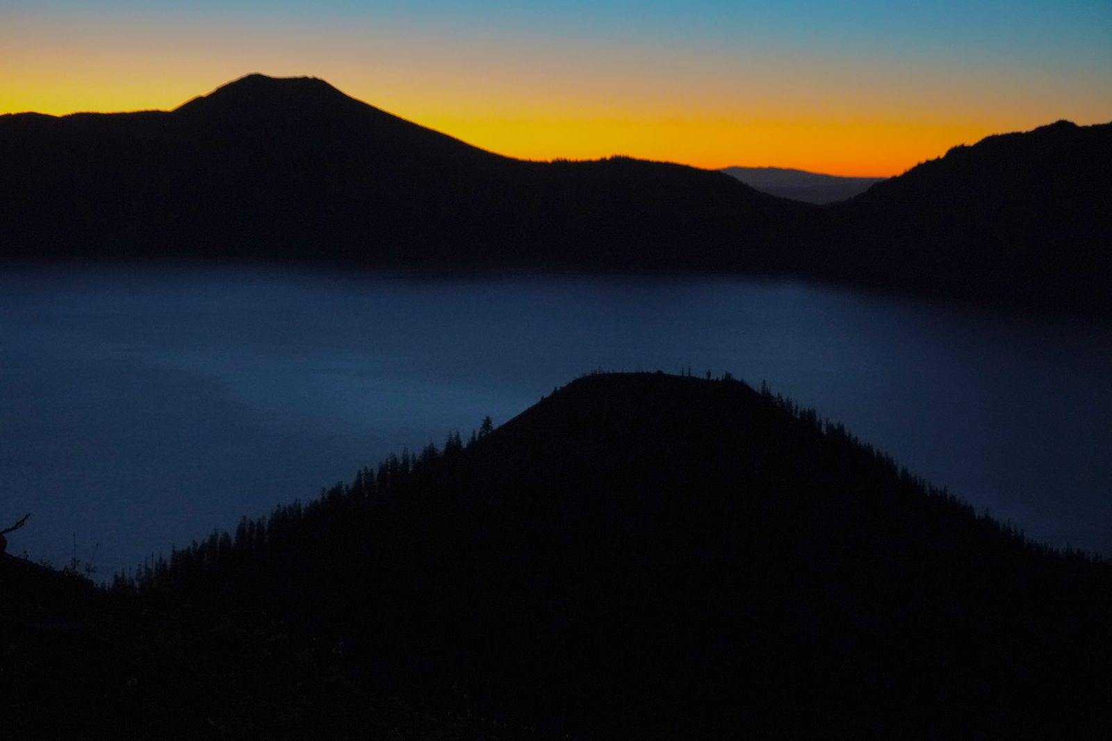 Crater Lake with a wooded island at twilight