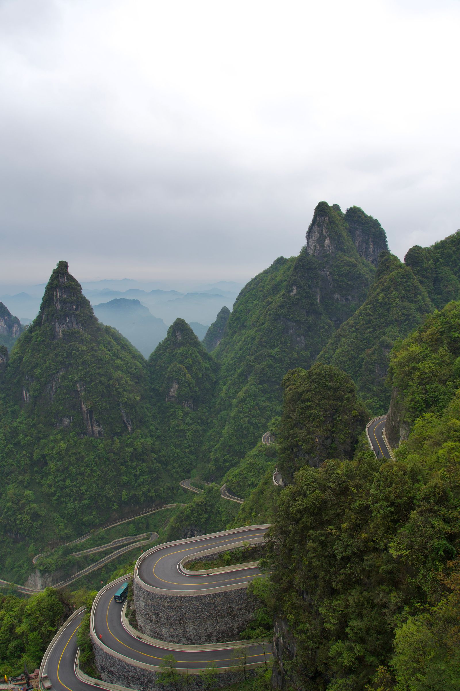 Forested peaks above a winding road with hairpin bends, Zhangjiajie