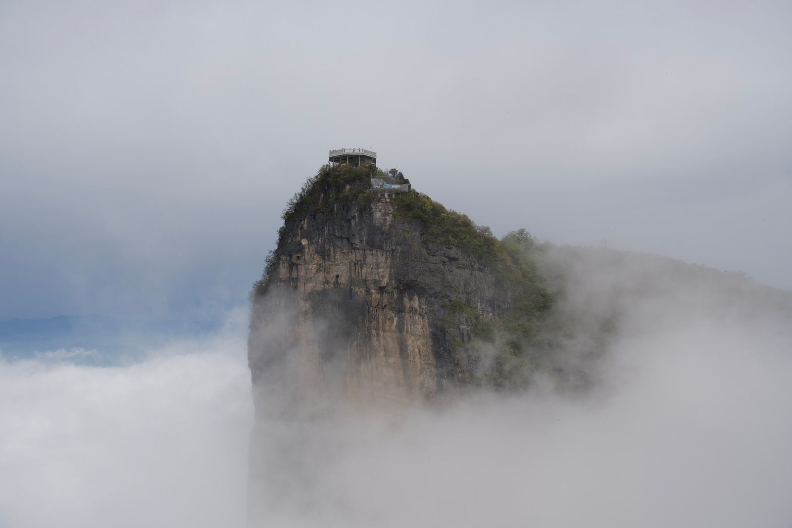 A rocky peak with a summit viewing platform in fog, Zhangjiajie