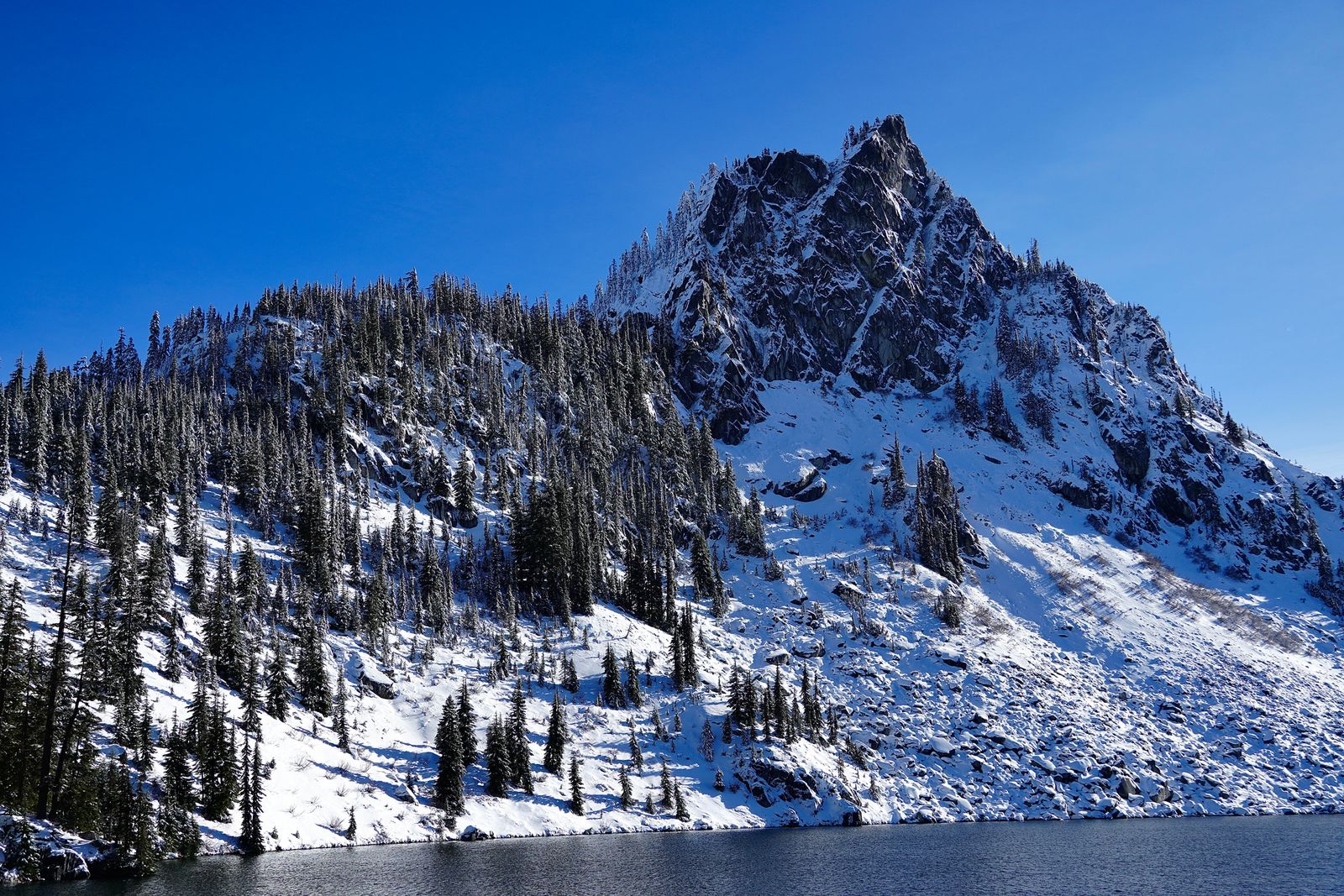 Snow-covered rocky peak above Lake Valhalla