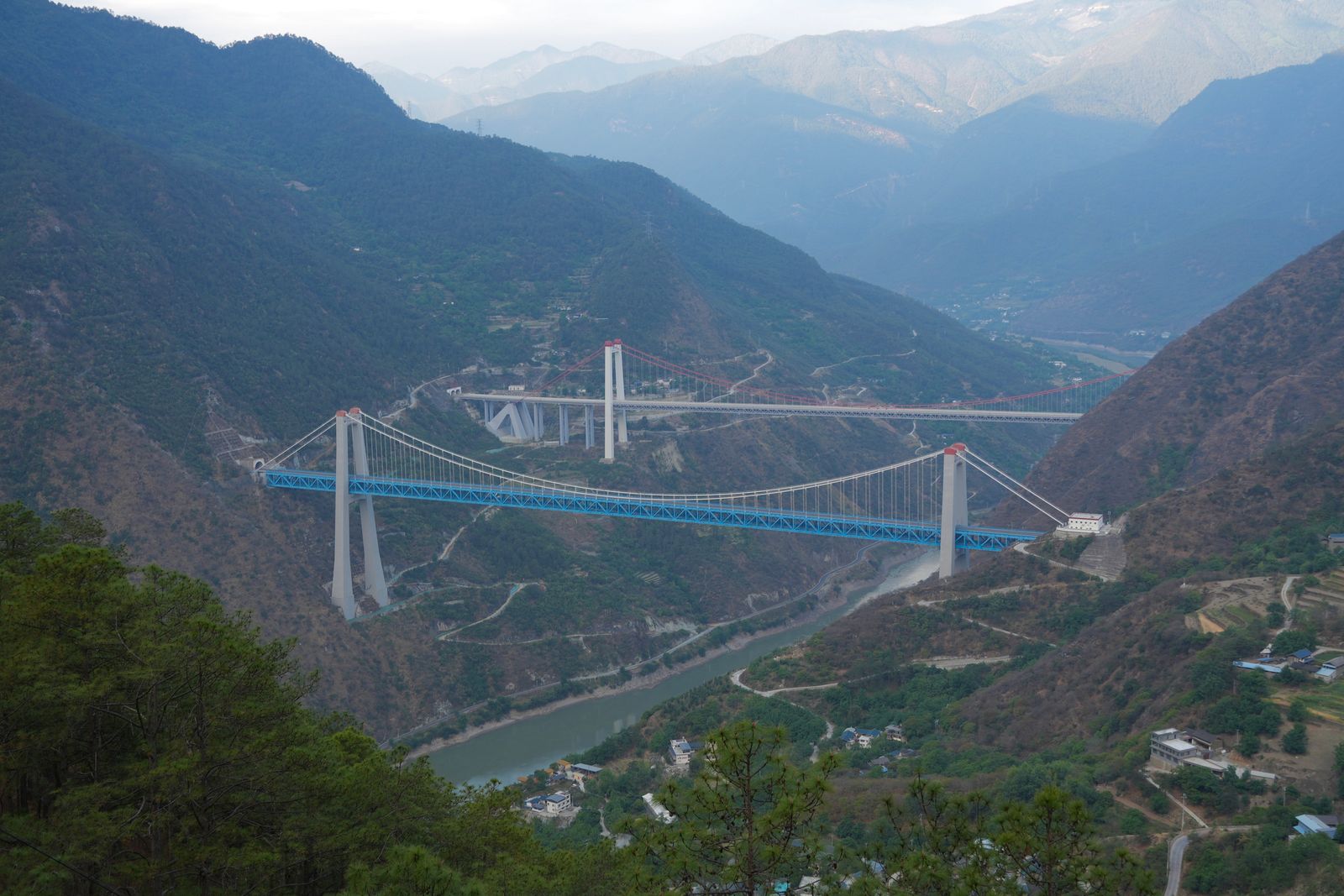 Two suspension bridges over the river in Tiger Leaping Gorge