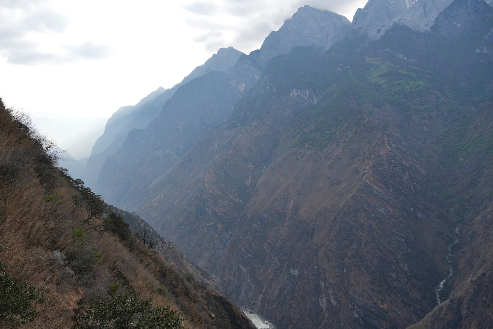 Tiger Leaping Gorge with steep rocky walls in haze
