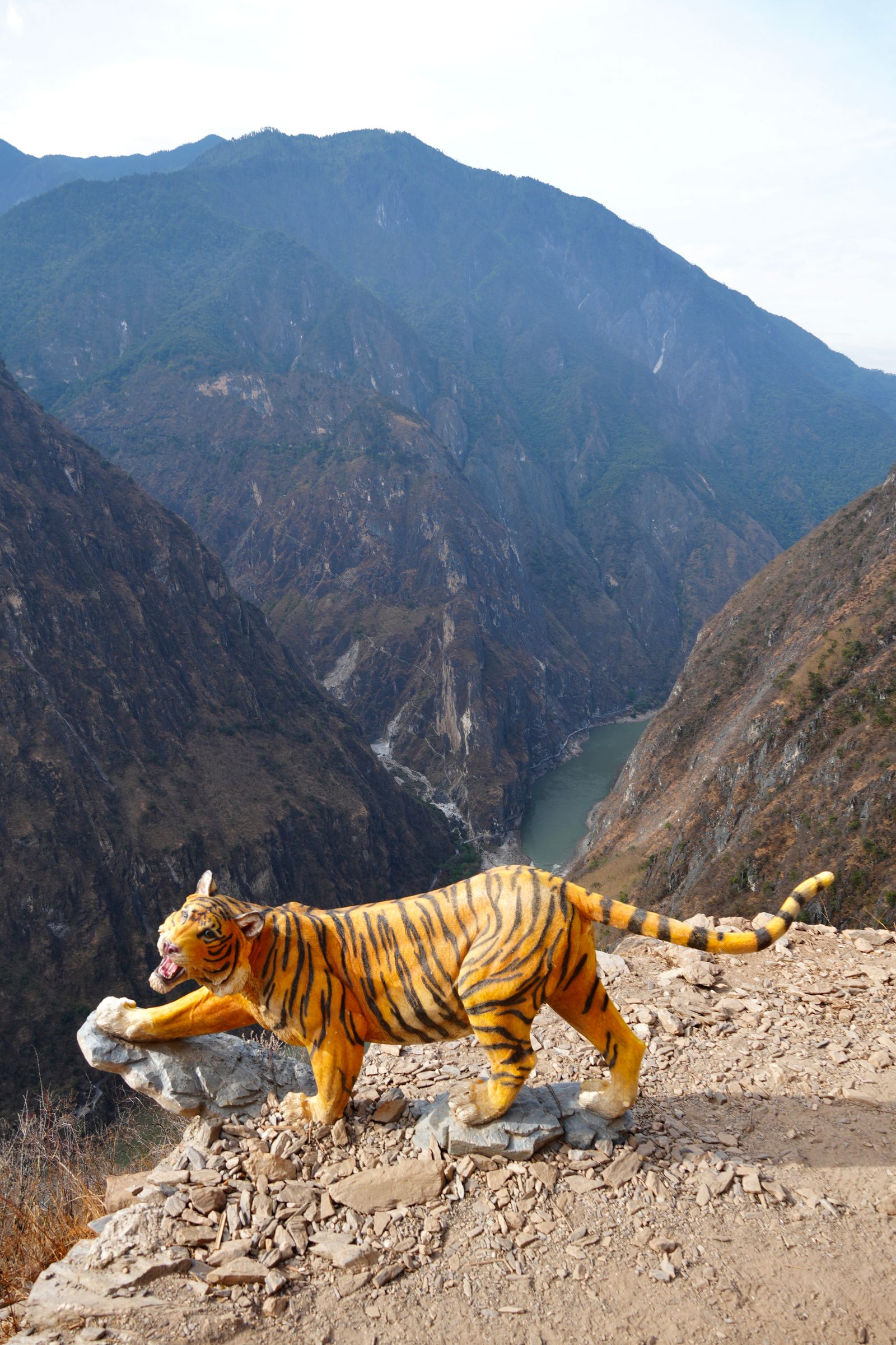 Striped cat statue above the river in Tiger Leaping Gorge