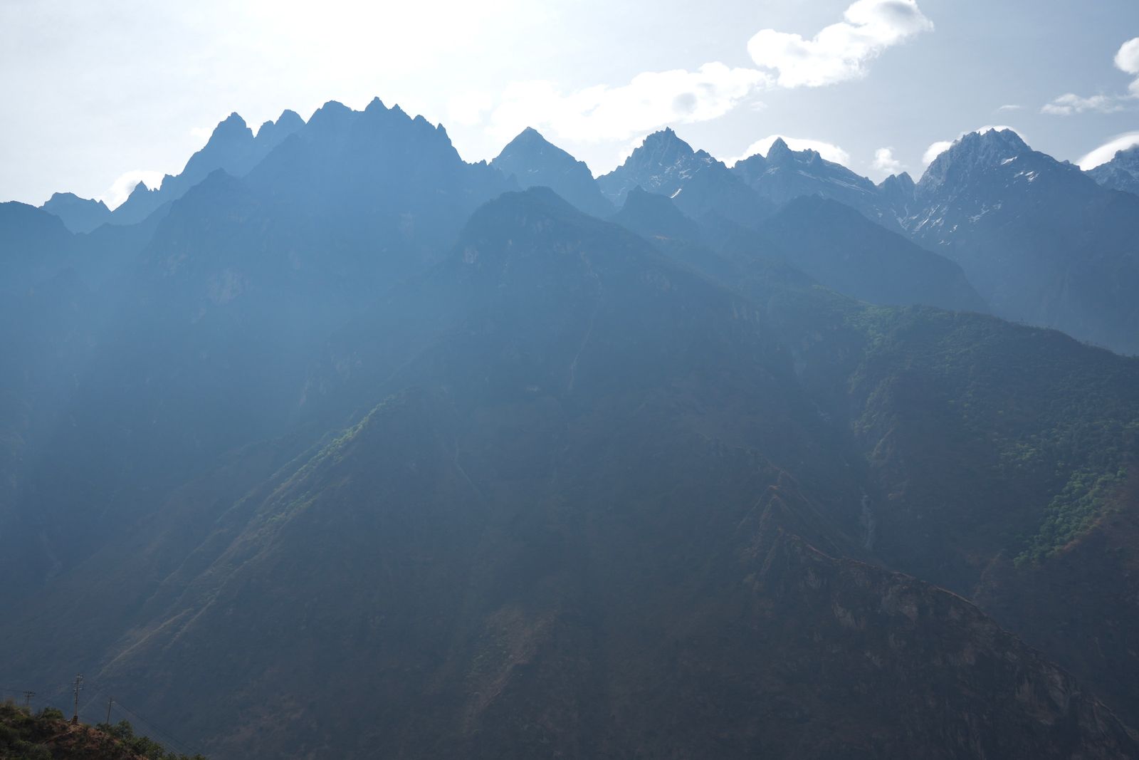 Backlit jagged mountain peaks with patches of snow, Tiger Leaping Gorge