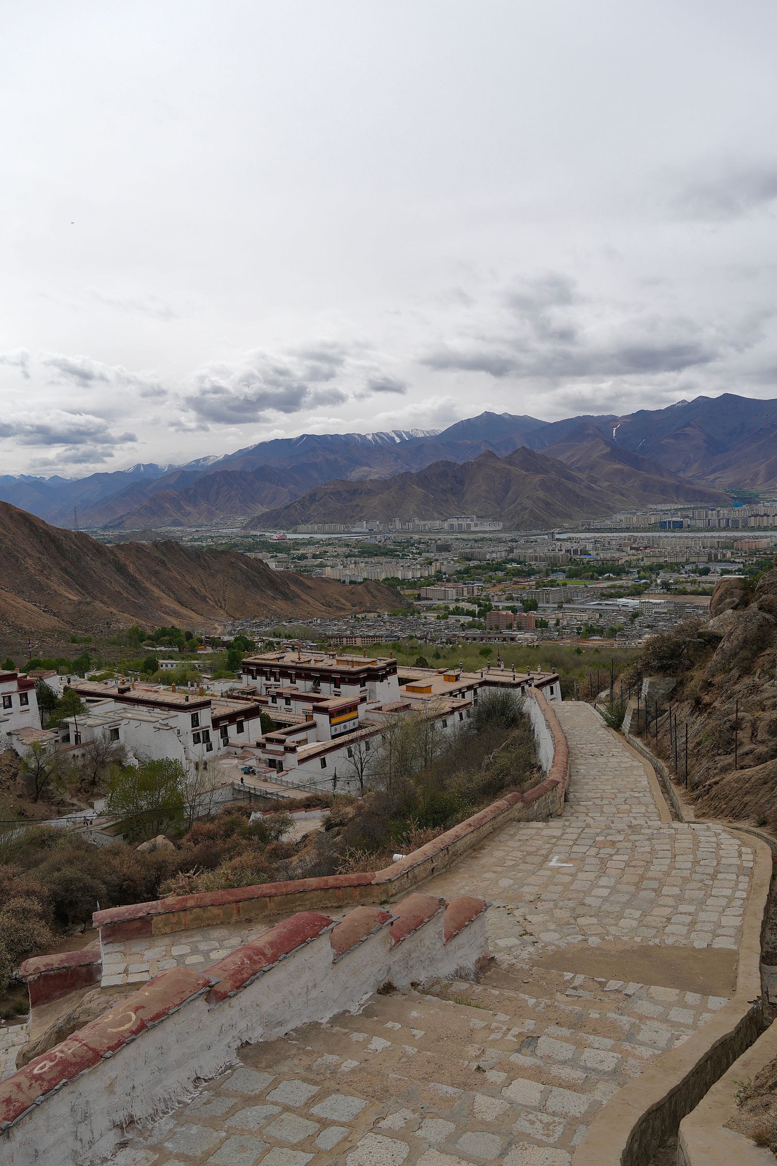 Stone stairway above buildings in a mountain valley, Tibetan plateau