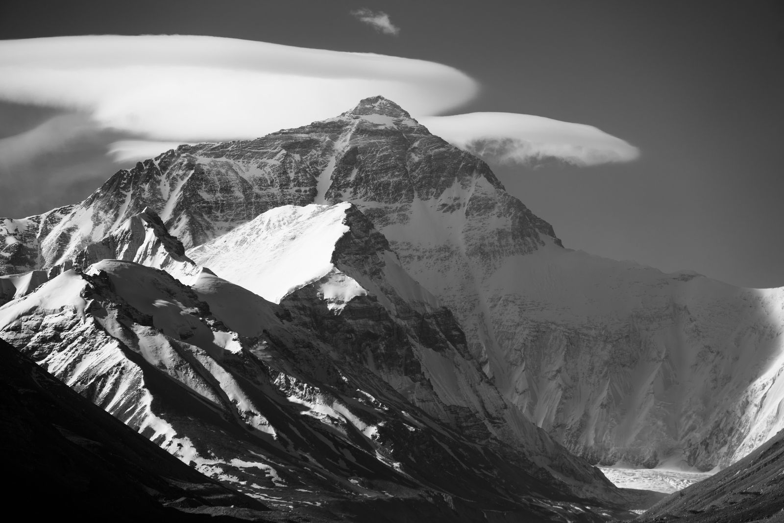 Mount Everest in black and white beneath layered clouds