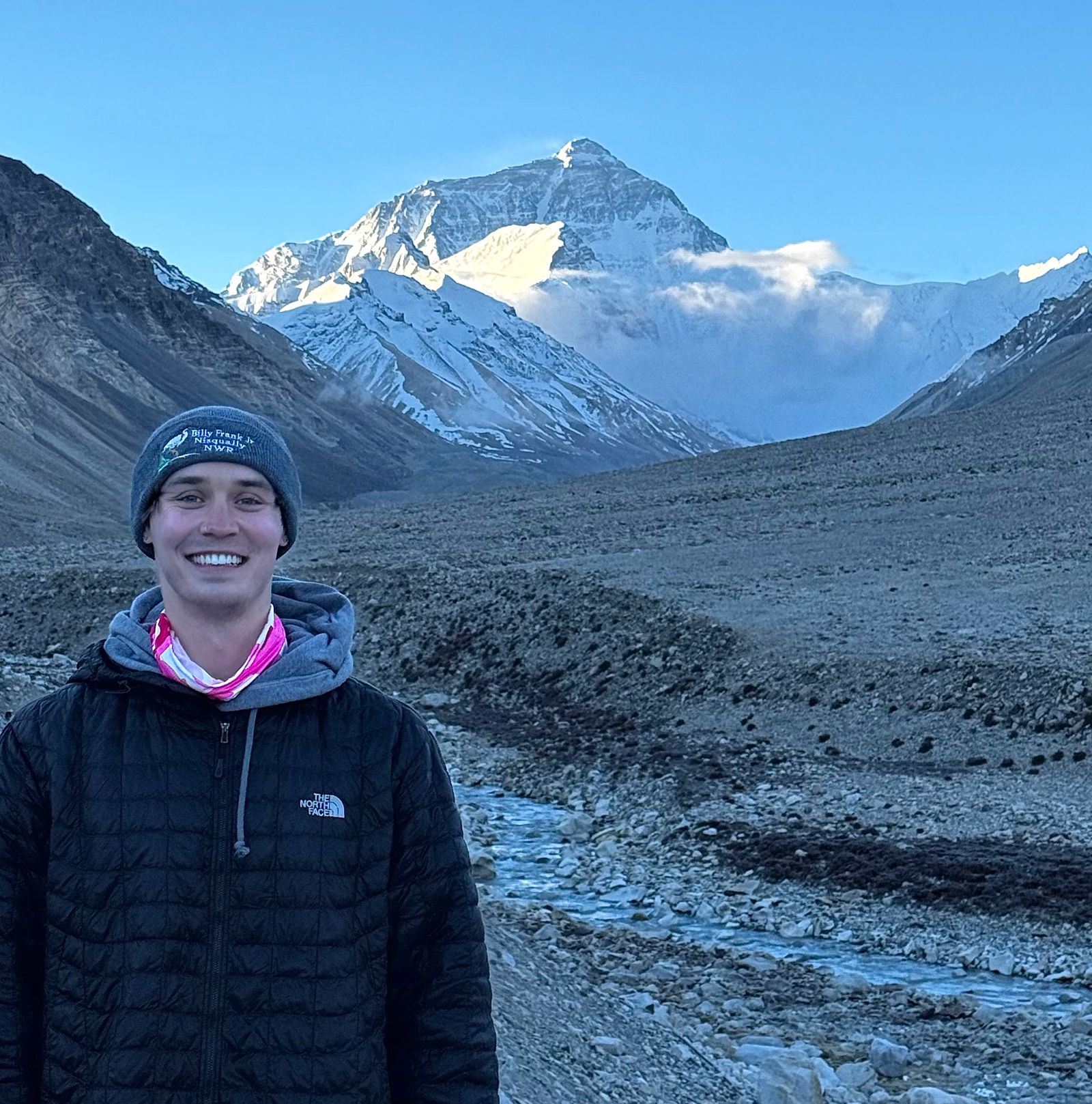 A person beside a stream below Everest north face