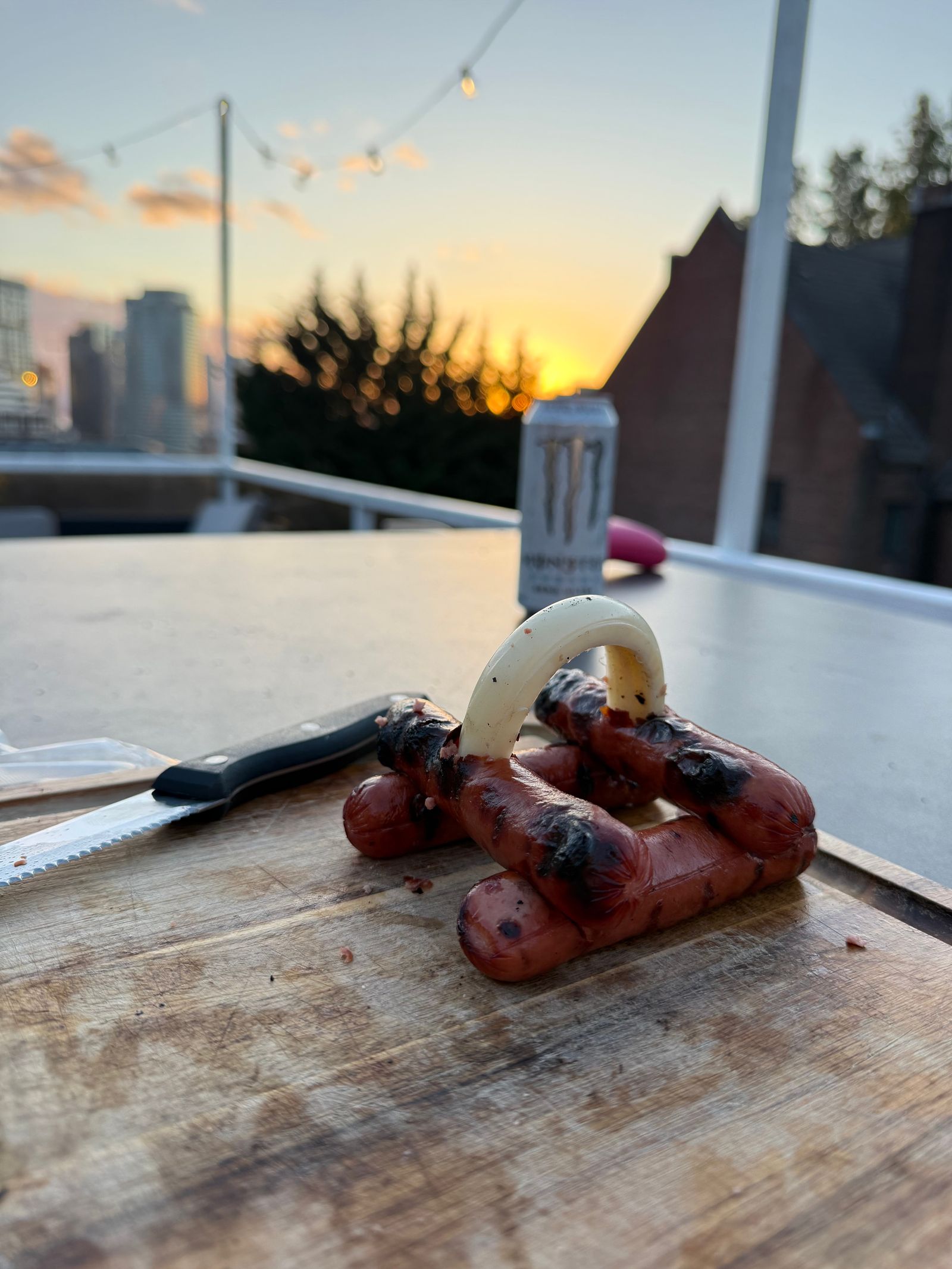 Grilled sausages beneath an onion slice at sunset, Ball Mountain
