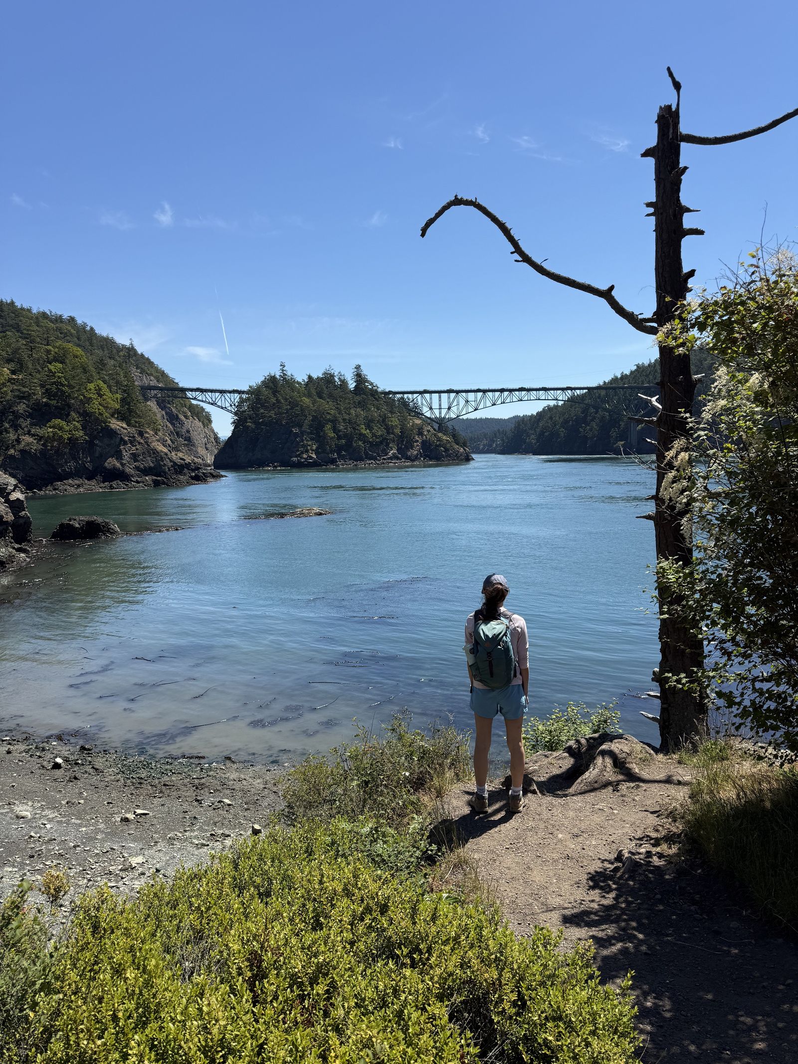 Deception Pass with a hiker on a shoreline trail