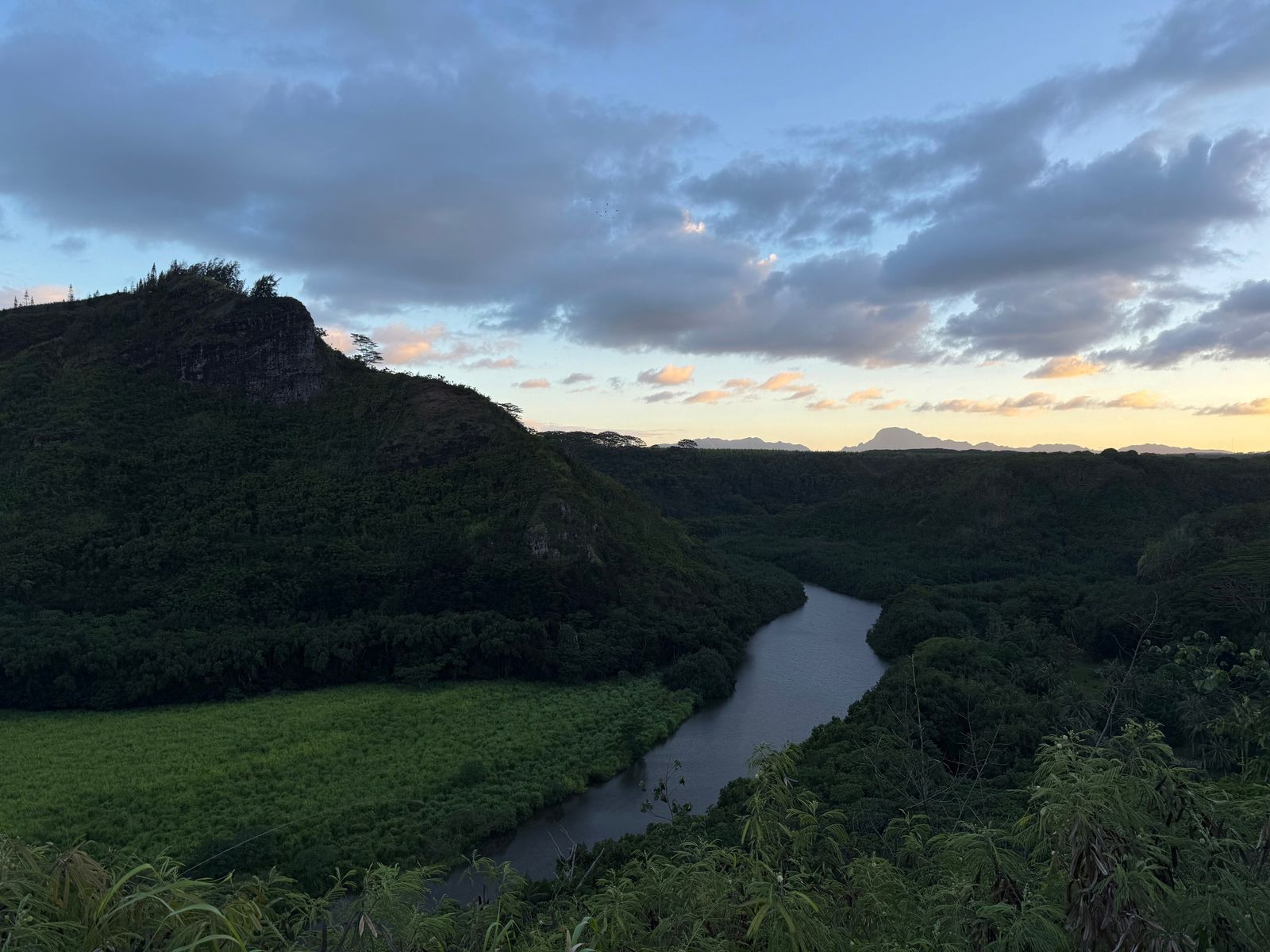 River winding through a valley below wooded hills, Napali Coast
