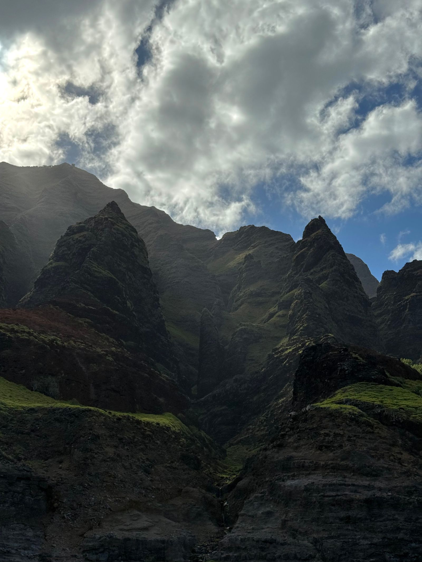 Napali Coast ridges surrounding a deep ravine beneath thick clouds